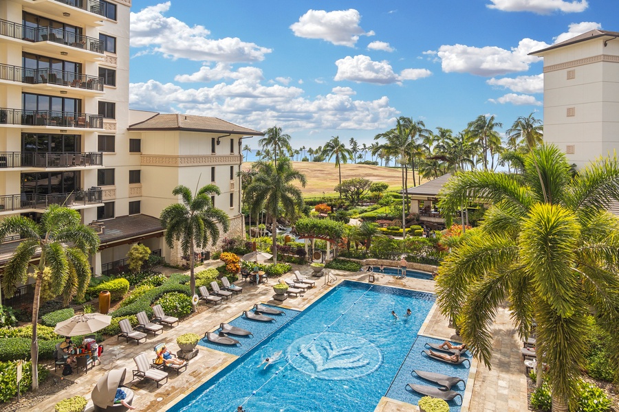 Resort pool view from the lanai with a glimpse of the ocean.