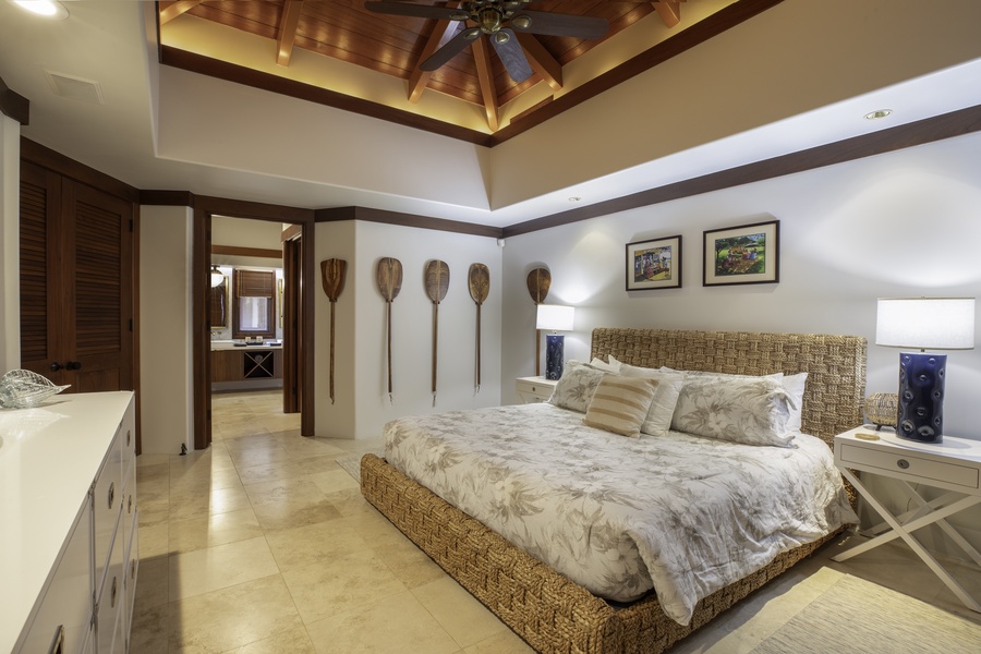 Unwind in your tropical-inspired master suite featuring soaring wood beam ceilings and nautical touches that create a serene island escape.