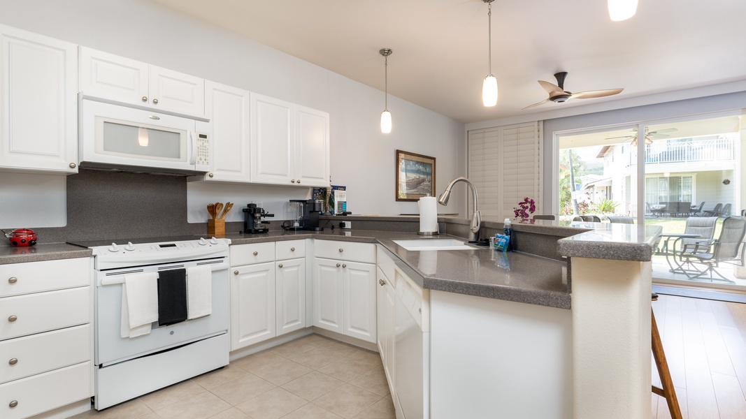 A bright kitchen with numerous amenities including a wine fridge.