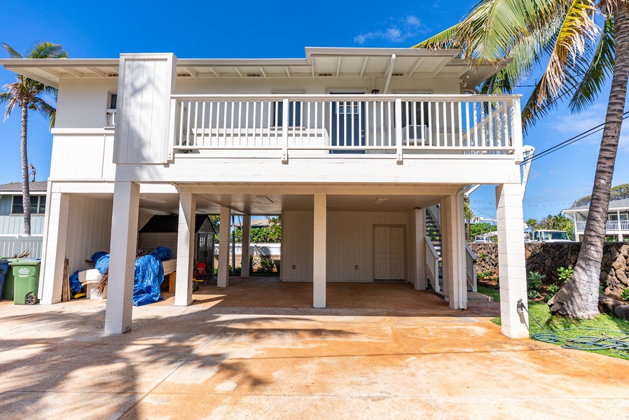 Elevated home design with secured parking and tropical landscaping at Ohana Island Retreat.