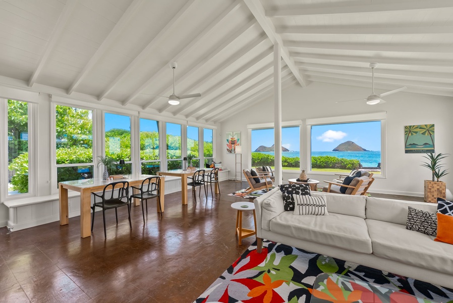 Relax in this bright, open living space with sweeping ocean views and island peaks framing your stay. High vaulted ceilings and natural light create a warm, inviting retreat.
