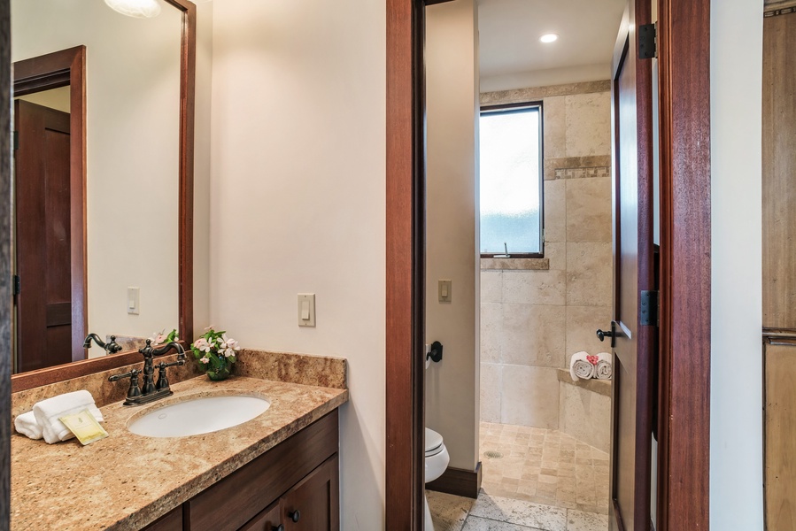 The fourth ensuite bath w/ travertine shower.