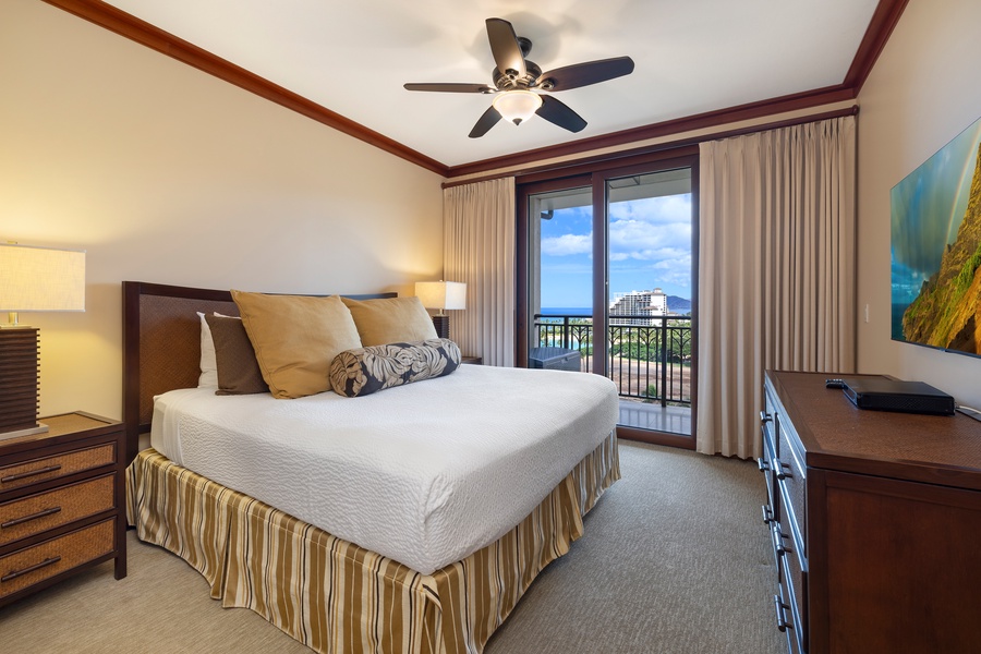 The primary suite offers a king-size bed, ocean views, and direct access to the lanai.