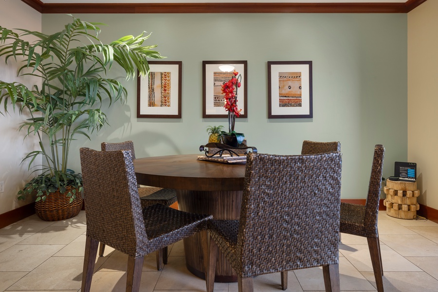Dining area with vibrant artwork, and a large plant adding a touch of greenery.