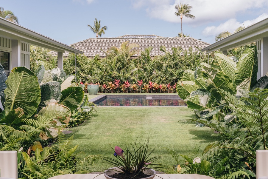 Lush gardens and an open lawn create a welcoming outdoor gathering space.
