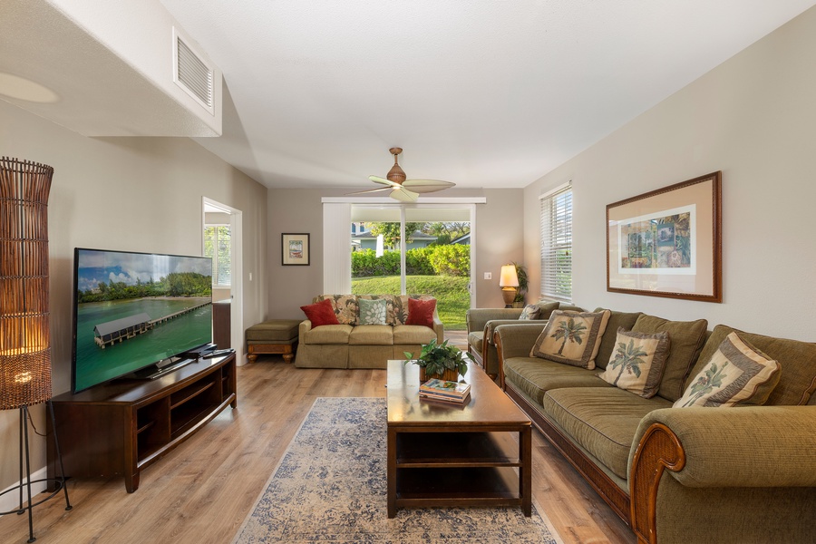 Settle into your spacious living room with tropical touches, where you'll enjoy relaxing on plush sofas while watching the large TV.