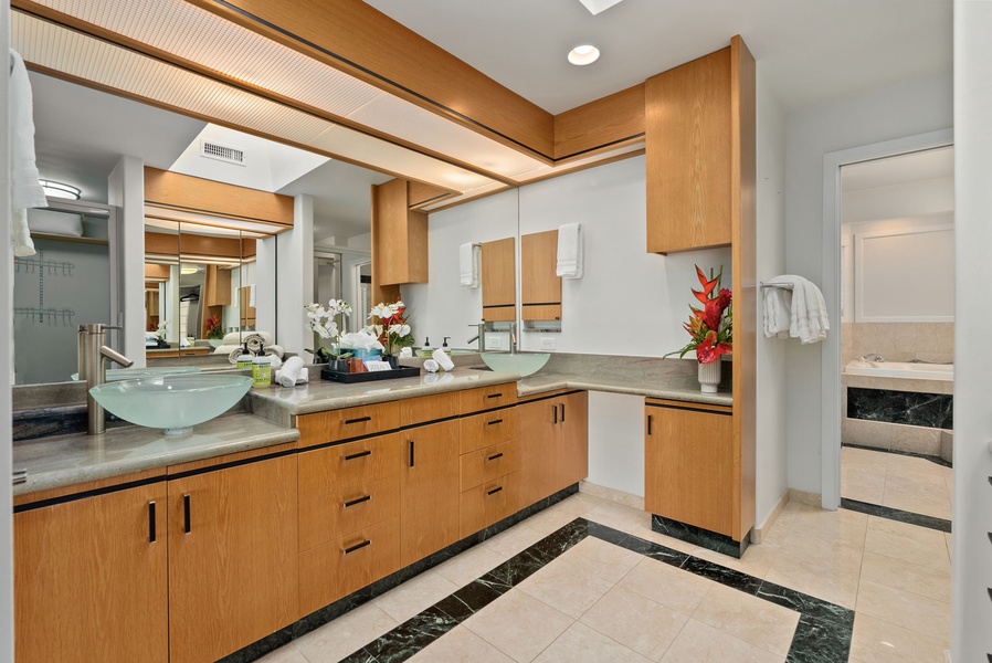 The spa-like ensuite bathroom has three vanity spaces.