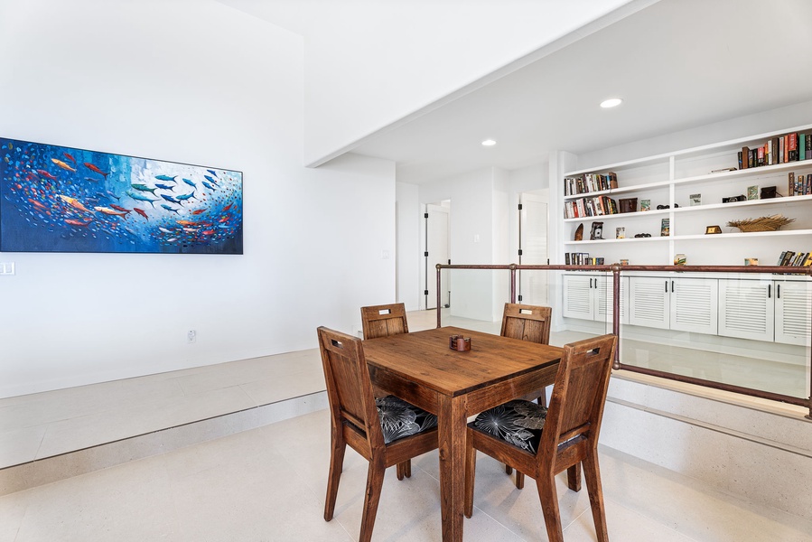 Dedicated game or breakfast table creates a versatile nook, ideal for morning journaling, evening cards, or light meals between dips.