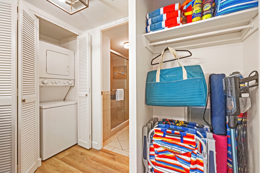 The laundry area at Mahana 1118 comes equipped with washer, dryer, and neatly stored beach gear.
