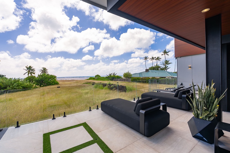 Open lanai with lounge seating and unobstructed coastal views.