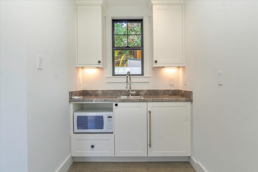 Charming kitchenette in the carriage house with microwave and sink.