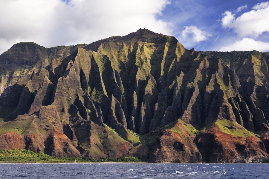 Majestic cliffs meet the sparkling ocean at sunset.