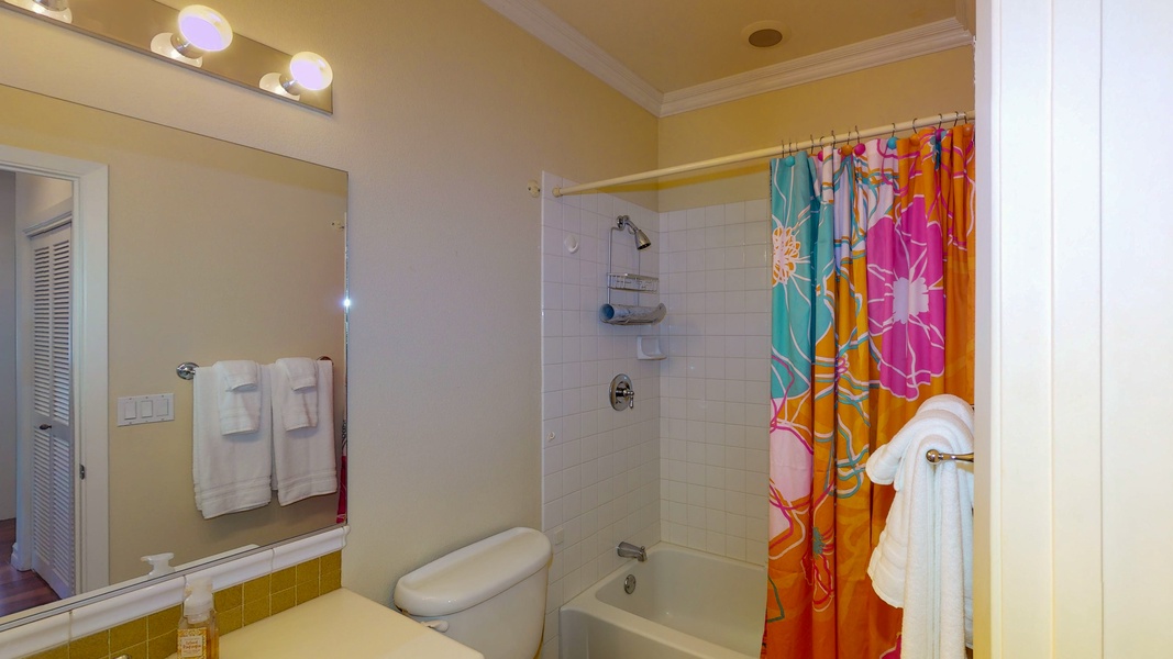 The guest bathroom has a tub/shower combo and plenty of storage.