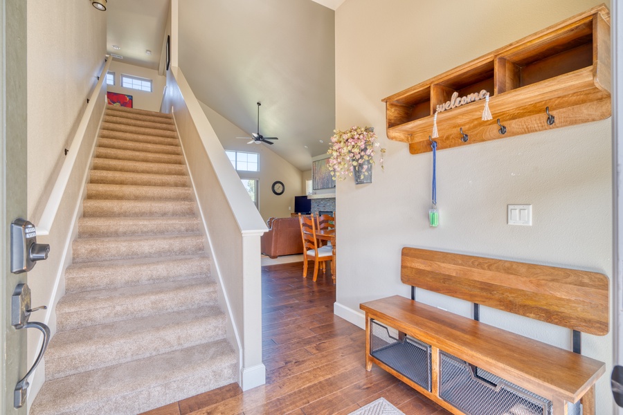 As you enter the home through the front door, you'll find a welcoming space to sit, remove your shoes, and organize your personal items. Stairs lead to the second floor, setting the stage for your comfortable and convenient stay