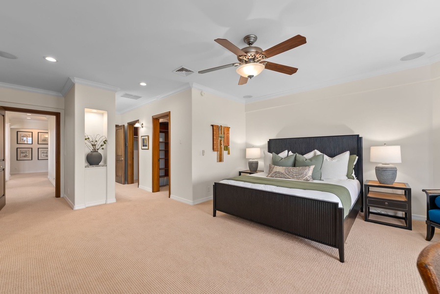 Sink into plush bedding and unwind in a spacious bedroom designed for restful island evenings.