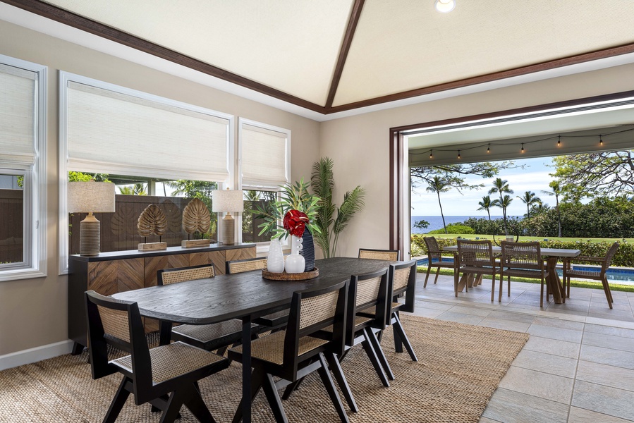 The lanai doors open onto dinner with the fairway greens filling the far end.