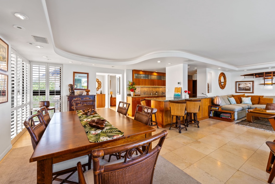 Elegant dining area with seating for family or friends, featuring tropical decor and beautiful lighting for enjoyable meals.