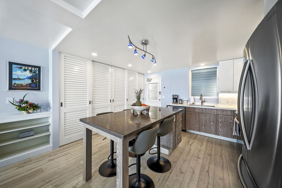 Your fully-equipped modern kitchen features granite countertops, stainless steel appliances, and a spacious island perfect for cooking and gathering together.