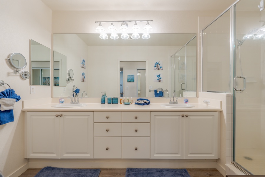 The spacious guest bathroom with a large vanity and ample lighting.