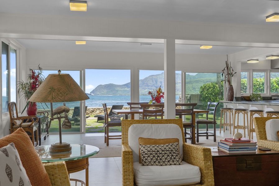 Witness the breathtaking ocean views from your bright living space, where island-style furnishings frame stunning mountain vistas across the water.