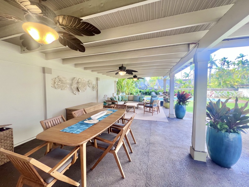 Outdoor dining area with seating for 8, surrounded by lush greenery and perfect for al fresco meals.