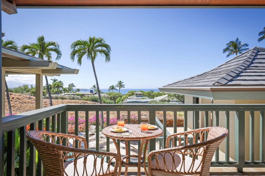 The lanai for the second bedroom features seating for two and views of the horizon