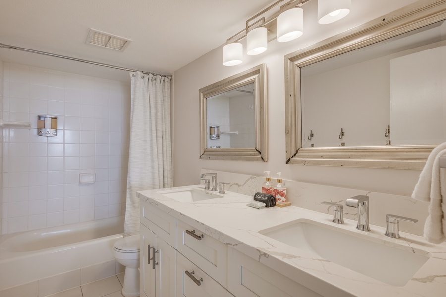 The ensuite bath has dual vanities and a shower/tub combo.