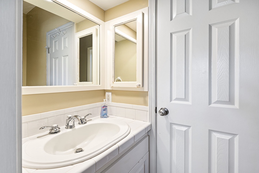 Secondary vanity in the guest bathroom allows for extra space and functionality.