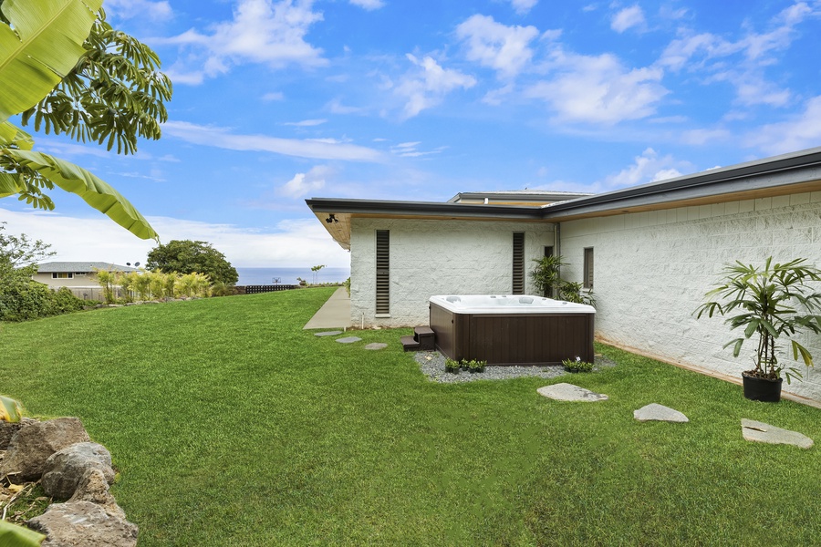 Jacuzzi set in a private area of the property with grassy surroundings and mountain air.