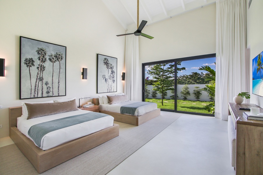 Unwind in the spacious guest bedroom with two beds and a view of the garden.