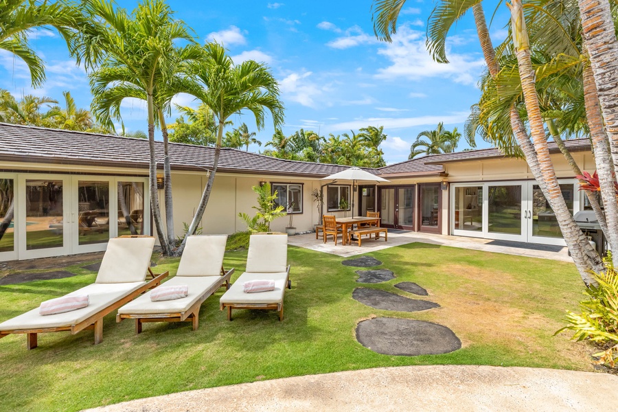 Sun-drenched backyard oasis with comfortable lounging, perfect for relaxation and entertainment in your private slice of paradise.