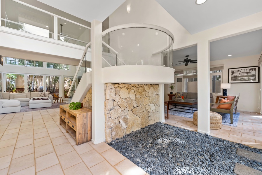 Stunning architectural sanctuary with soaring ceilings, a dramatic stone fireplace, and bright open spaces perfect for unwinding.