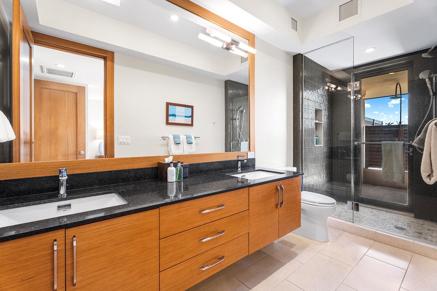 Ensuite bath with dual sinks and walk-in glass shower.