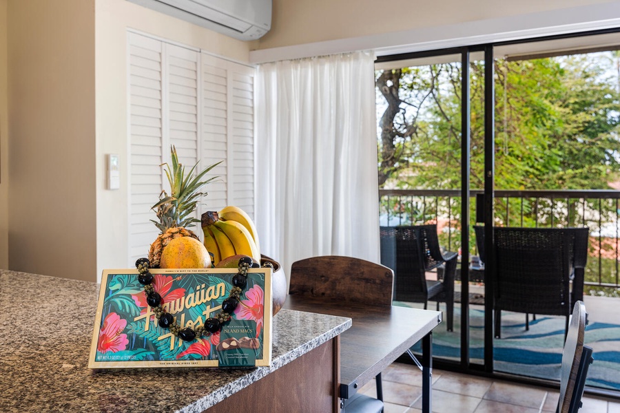Your kitchen overlooks lush greenery through floor-to-ceiling windows, creating a bright, airy space for preparing tropical treats.