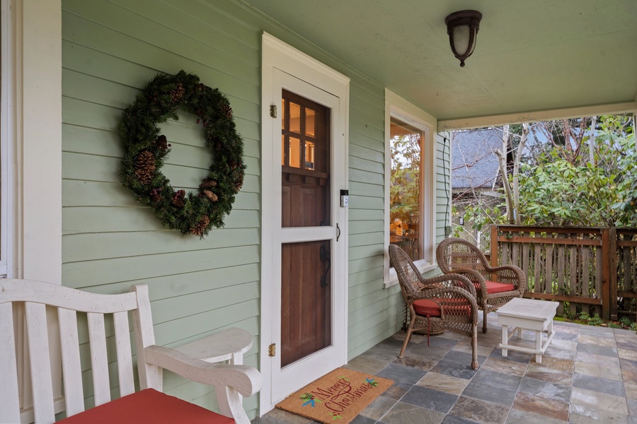 Front porch featuring a holiday wreath and rocking chairs, perfect for enjoying the season.