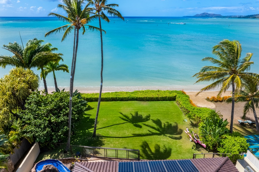 Expansive beachfront lawn with stunning ocean views, perfect for relaxation and play.