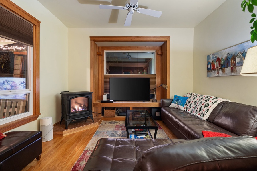 Living room with a glowing fireplace, creating the perfect ambiance for a festive evening.