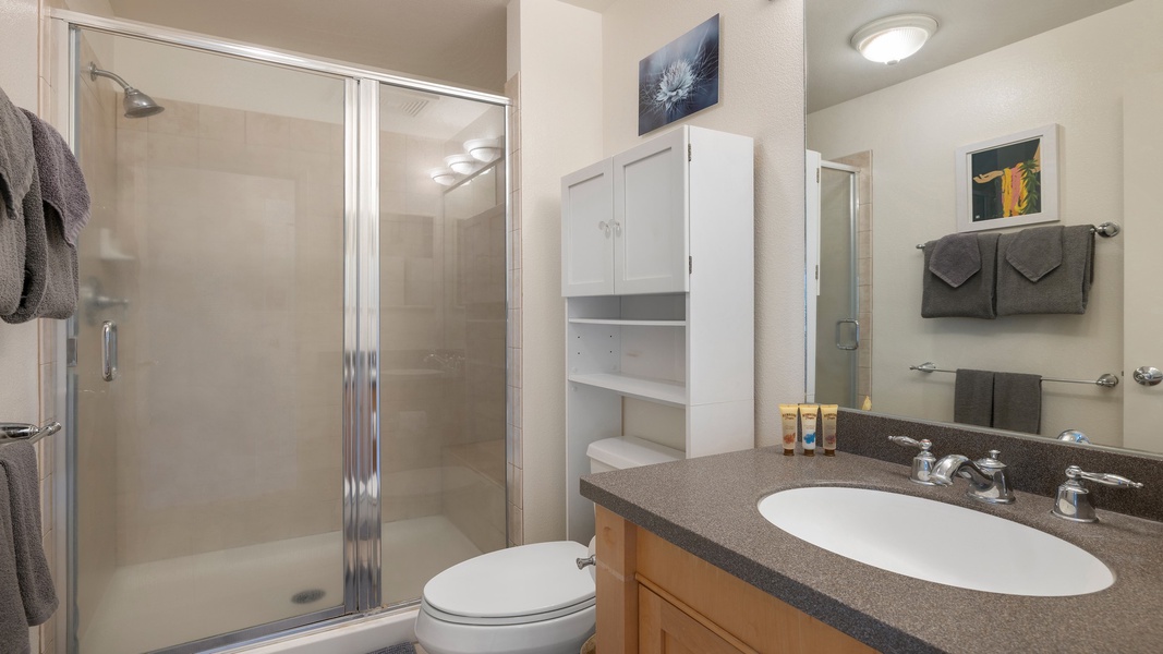 The ensuite bathroom features a walk-in shower, sleek vanity, and thoughtful touches designed for comfort and functionality.