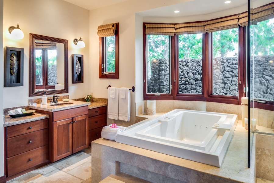 The primary bath w/ a luxurious jetted tub & dual vanity sinks.