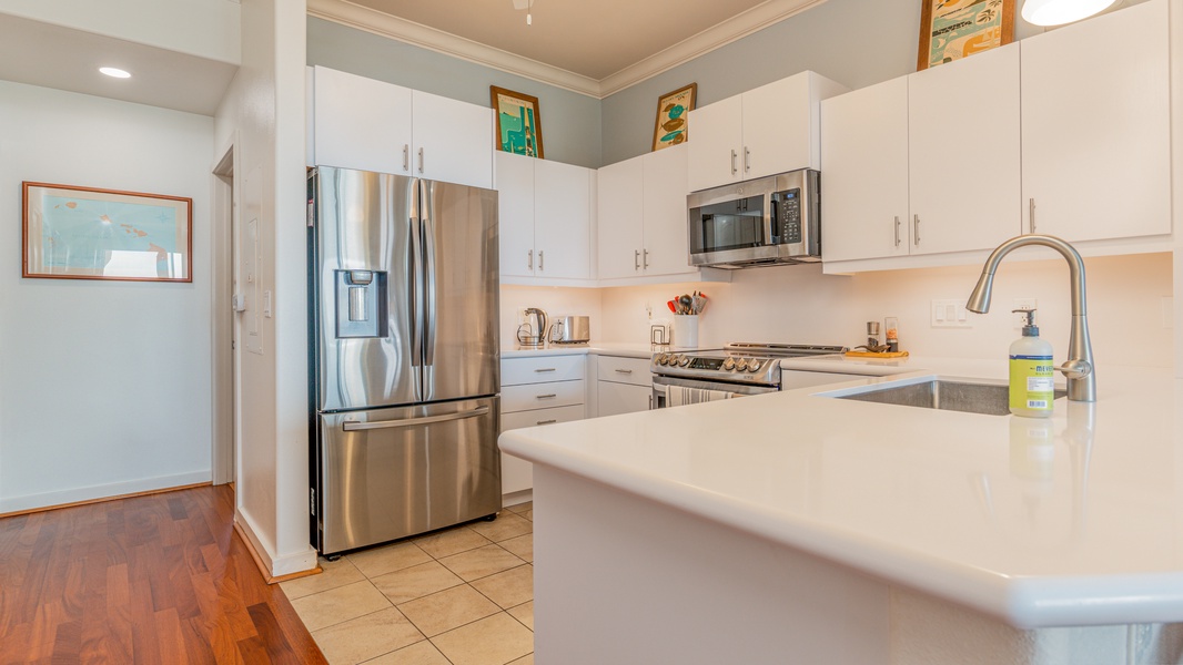 The bright open kitchen with stainless steel appliances.