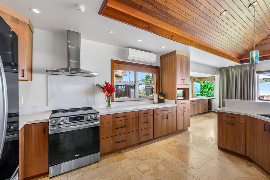 Bright, open kitchen layout with natural stone counters and ample prep space for island-style entertaining.