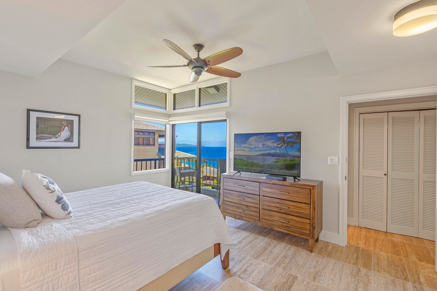 Wake up to stunning ocean views from this cozy bedroom, featuring a private lanai and a flat-screen TV