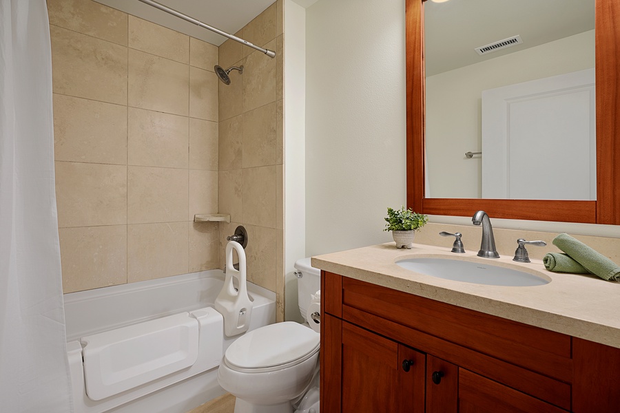 Full bathroom with shower and tub combo, perfect for refreshing after beach days.