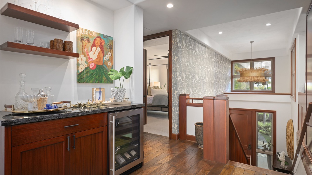 The den features an extra layer of luxury, complete with a wet bar.