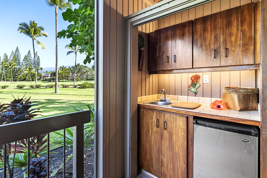 Your tropical kitchenette welcomes you with warm wood tones and everything needed for island living, framed by swaying palms.