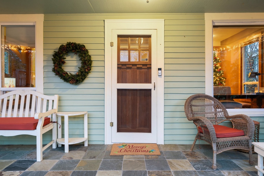 A cheerful front porch welcomes you with seasonal charm and cozy seating.