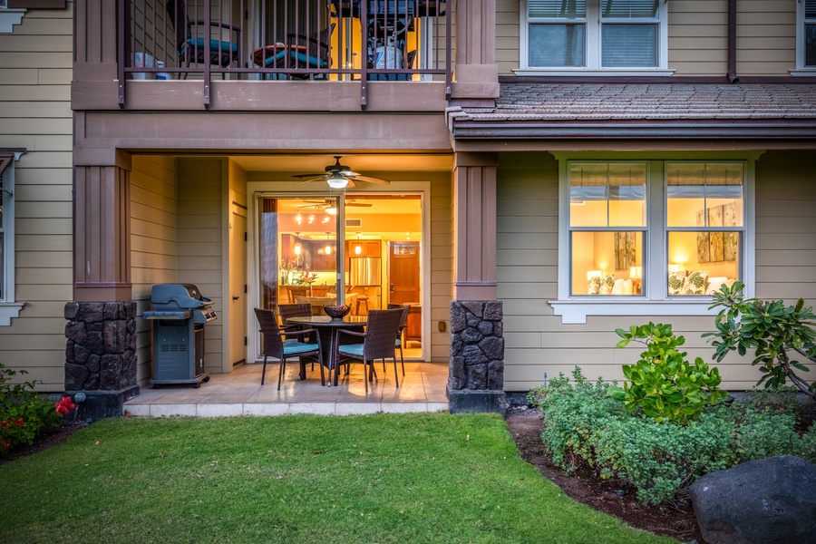 Reverse view of the lawn and lanai space at twilight, with view of our 3 BD condo directly above, 12G - perfect to rent together for large groups!