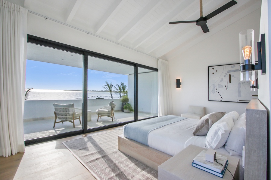 Stunning ocean views in this cozy guest bedroom with modern decor.