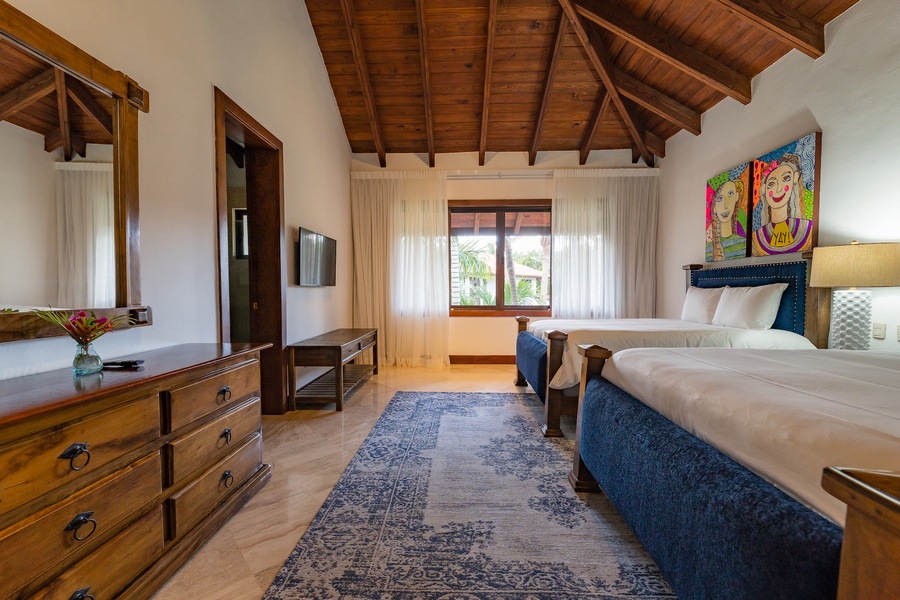Indulge in the guest bedroom with two comfortable beds, and ample natural light