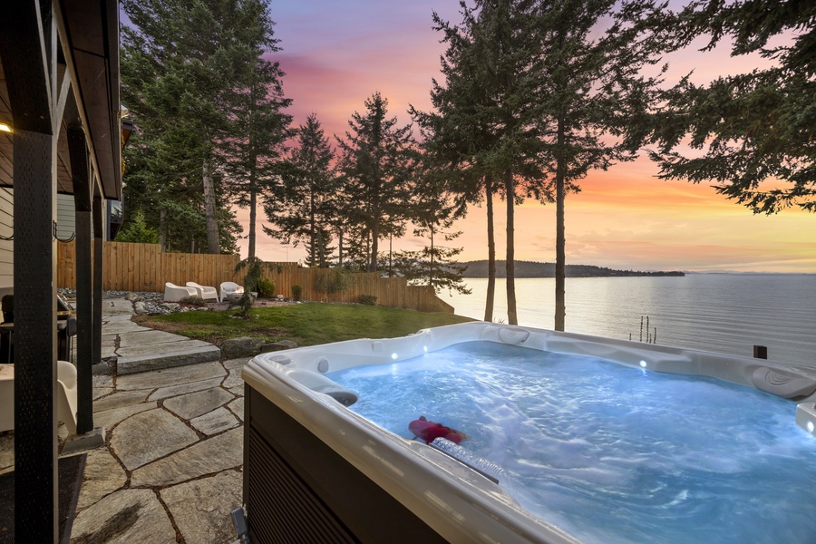 Soak under the stars in the bubbling hot tub as the sky turns shades of amber and rose.